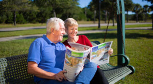 Two of our avid readers sitting on a bench enjoying our community publication