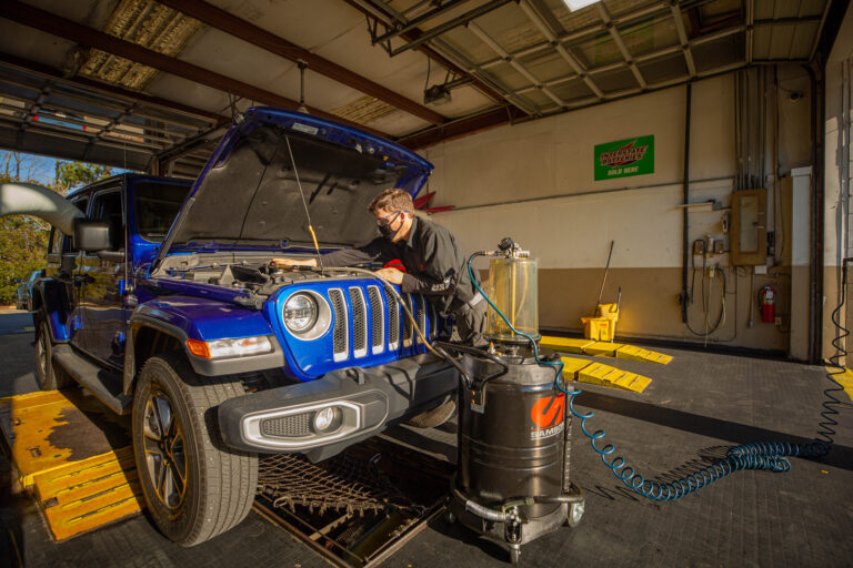 mechanic works on cars