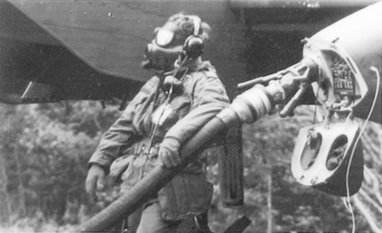 A soldier during Thunderhog excercises practices refueling in a chemical environment