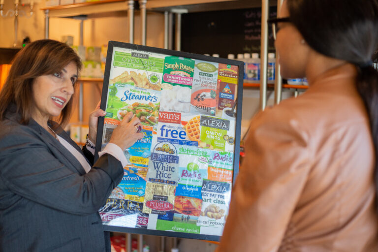 picture of woman holding a health diagram, showing it to another woman