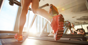 Person Running on a Treadmill in Orange Sneakers