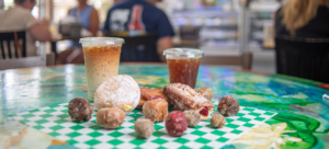 Two iced coffees with a pile of donuts in Benjamin's Bakery Cafe in Surfside Beach, SC