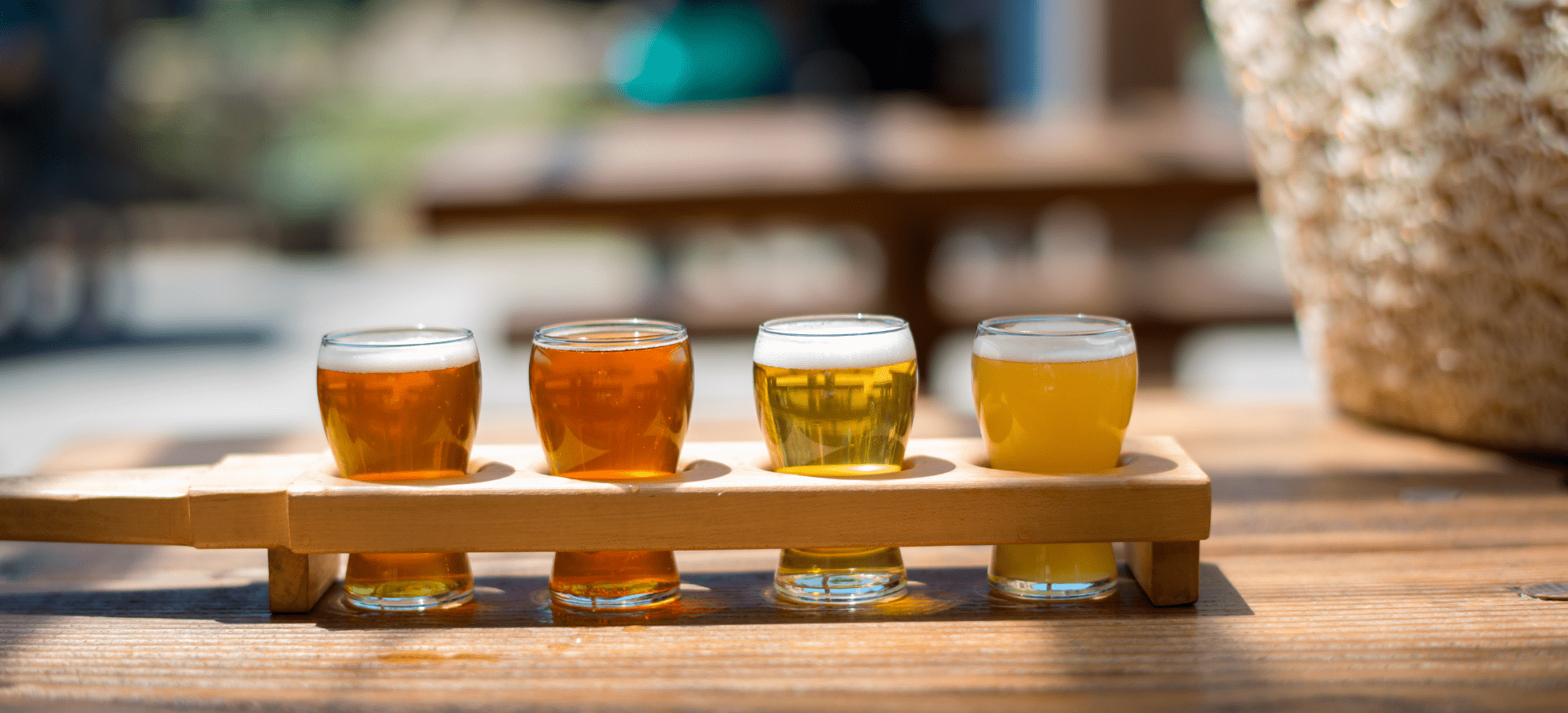 flight of different types of beer with a basket in the corner as decoration