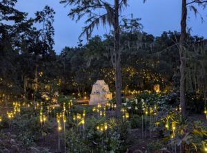 Brookgreen Gardens in Myrtle Beach featuring lights in a garden with a statue and flowers around it