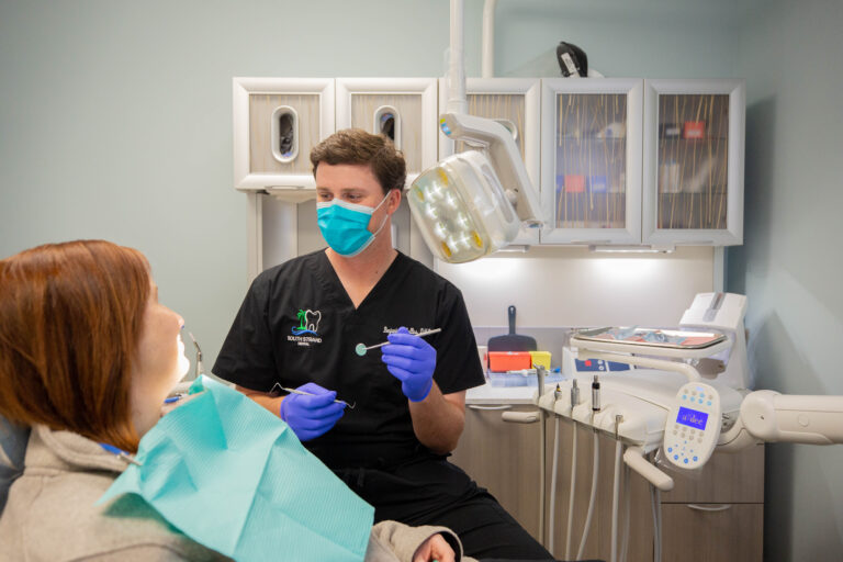 Dr. Benjamin H. Collins examines a patient in the newly renovated office.