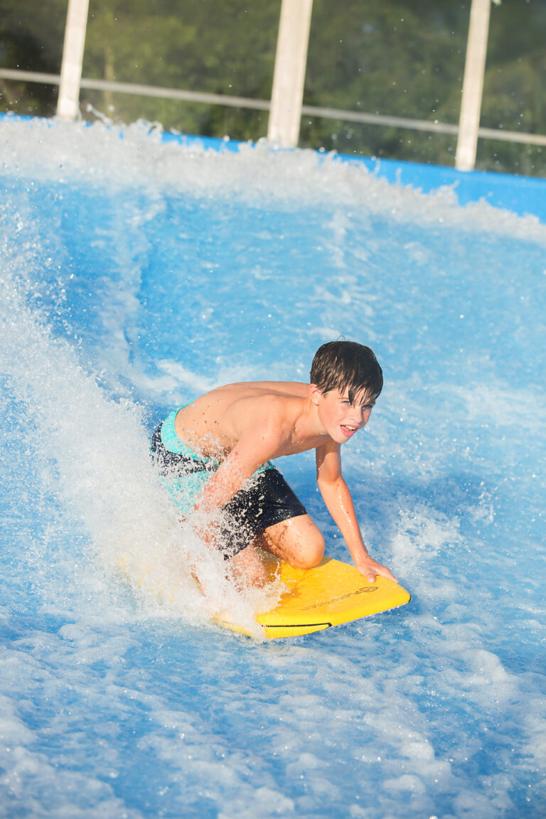 Picture of child knee-boarding on the Myrtle Waves, flowrider