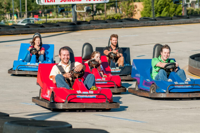 picture of group of young adults racing in go-karts