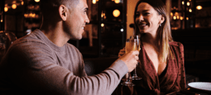 Couple at a date night having a glass of champagne enjoying a night out.
